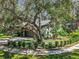 Side view of house with lush landscaping and a long driveway at 2728 Saint Cloud Oaks Dr, Valrico, FL 33594