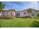 Pink house with a large window reflecting the waterway at 1301 Sea Gull S Dr, St Petersburg, FL 33707