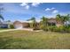 Pink house with a white garage door and landscaped yard at 1301 Sea Gull S Dr, St Petersburg, FL 33707