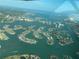 Aerial view of a waterfront community with unique island-shaped houses and lush greenery at 7886 9Th S Ave, St Petersburg, FL 33707
