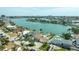 Aerial view of waterfront homes, each with private docks, landscaped yards, and backyard pools at 7886 9Th S Ave, St Petersburg, FL 33707