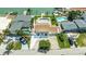 Eye-level aerial view showcasing a home with backyard pool, and private dock along a waterfront canal at 7886 9Th S Ave, St Petersburg, FL 33707