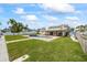 Beautiful backyard showcasing a covered patio, sparkling pool, and lush greenery at 7886 9Th S Ave, St Petersburg, FL 33707