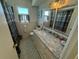 Bathroom with a granite countertop vanity, a window, and a shower with a curtain at 7886 9Th S Ave, St Petersburg, FL 33707