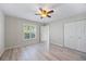 Bedroom with double closet, lots of light and featuring ceiling fan, and light floors at 7886 9Th S Ave, St Petersburg, FL 33707