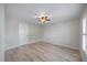 Minimalist bedroom with ceiling fan, light wood floors, and lots of natural light at 7886 9Th S Ave, St Petersburg, FL 33707