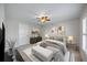 Cozy bedroom featuring neutral décor, ceiling fan, and ample natural light at 7886 9Th S Ave, St Petersburg, FL 33707