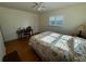 Bedroom featuring hardwood floors, a ceiling fan, and a desk area with a chair at 7886 9Th S Ave, St Petersburg, FL 33707