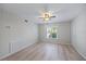 Bright bedroom featuring a ceiling fan, and a large window with blinds at 7886 9Th S Ave, St Petersburg, FL 33707