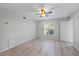 Bright bedroom featuring a ceiling fan, and a large window with blinds at 7886 9Th S Ave, St Petersburg, FL 33707