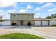 Charming two-story home featuring a covered porch, two-car garage, and well-manicured lawn at 7886 9Th S Ave, St Petersburg, FL 33707