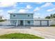 Charming two-story home featuring a covered porch, two-car garage, and well-manicured lawn at 7886 9Th S Ave, St Petersburg, FL 33707