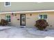 Welcoming front entrance with a decorative front door, well-manicured landscaping, and a charming brick facade at 7886 9Th S Ave, St Petersburg, FL 33707