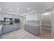 Bright kitchen with grey cabinets, stainless steel appliances, and a spacious pantry for ample storage at 7886 9Th S Ave, St Petersburg, FL 33707