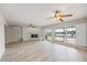 Bright and airy living room features a fireplace and sliders, offering serene water views and natural light at 7886 9Th S Ave, St Petersburg, FL 33707