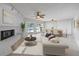 Spacious living room with a painted brick fireplace and sliders that offer beautiful views of the pool at 7886 9Th S Ave, St Petersburg, FL 33707