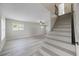 Bright living room featuring neutral paint, lots of natural light and a staircase at 7886 9Th S Ave, St Petersburg, FL 33707