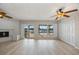 Bright and airy living room features a fireplace and sliders, offering serene water views and natural light at 7886 9Th S Ave, St Petersburg, FL 33707