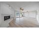 Bright living room with whitewashed brick fireplace and sliding doors to the pool at 7886 9Th S Ave, St Petersburg, FL 33707