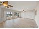Bright living room with sliding doors to deck and water views, features updated flooring at 7886 9Th S Ave, St Petersburg, FL 33707