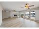 Bright and airy living room features a fireplace and sliders, offering serene water views and natural light at 7886 9Th S Ave, St Petersburg, FL 33707