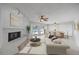 Spacious living room with a painted brick fireplace and sliders that offer beautiful views of the pool at 7886 9Th S Ave, St Petersburg, FL 33707