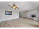 Open living room featuring neutral colors, ceiling fans, and light wood-look floors at 7886 9Th S Ave, St Petersburg, FL 33707