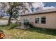 View of the backyard featuring a patio with black metal fencing and a well-maintained lawn at 802 Highgate Oaks Pl, Seffner, FL 33584