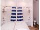 Bright bathroom with a double shower head and blue-and-white striped shower curtains at 802 Highgate Oaks Pl, Seffner, FL 33584