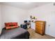 Simple bedroom design with desk, shelf and dresser in a neutral color palette at 802 Highgate Oaks Pl, Seffner, FL 33584