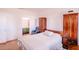 Bright bedroom featuring neutral walls and wood furniture, alongside a blue chair at 802 Highgate Oaks Pl, Seffner, FL 33584