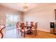 Cozy dining room with wood-look floors and sliding glass door to the backyard at 802 Highgate Oaks Pl, Seffner, FL 33584