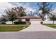 Charming single-story home with a well-maintained lawn and a two-car garage at 802 Highgate Oaks Pl, Seffner, FL 33584