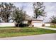 Well-kept single-story home with manicured lawn, an attached two-car garage, and privacy fence at 802 Highgate Oaks Pl, Seffner, FL 33584