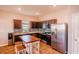 Modern kitchen with stainless steel appliances, dark wood cabinets, and granite countertops at 802 Highgate Oaks Pl, Seffner, FL 33584