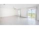 Bright living room with tile floors and access to backyard at 14906 Imperial Purple Ln, Wimauma, FL 33598