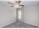 Bedroom with gray carpet, window with curtains, and ceiling fan at 14906 Imperial Purple Ln, Wimauma, FL 33598
