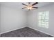 Simple bedroom with gray carpet and ceiling fan at 14906 Imperial Purple Ln, Wimauma, FL 33598
