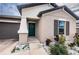 House exterior with teal front door and landscaping at 14906 Imperial Purple Ln, Wimauma, FL 33598
