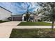 House exterior with landscaping and driveway at 14906 Imperial Purple Ln, Wimauma, FL 33598