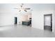 Open living room with kitchen island, tile floors, and ceiling fan at 14906 Imperial Purple Ln, Wimauma, FL 33598