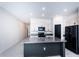 Modern kitchen with island and stainless steel appliances at 14906 Imperial Purple Ln, Wimauma, FL 33598