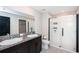 Bathroom with dual sinks, granite countertop, and large shower at 14906 Imperial Purple Ln, Wimauma, FL 33598