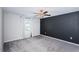 Bright bedroom featuring gray carpet and window with curtains at 14906 Imperial Purple Ln, Wimauma, FL 33598