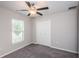 Bedroom with gray carpet, window blinds, and double doors at 14906 Imperial Purple Ln, Wimauma, FL 33598