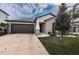 House exterior with landscaping and driveway at 14906 Imperial Purple Ln, Wimauma, FL 33598