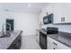 Modern kitchen with granite countertops and stainless steel sink at 14906 Imperial Purple Ln, Wimauma, FL 33598