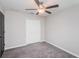 Bedroom with gray carpet, double doors, and ceiling fan at 14906 Imperial Purple Ln, Wimauma, FL 33598