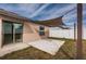 Backyard patio with shade sail and grassy area at 14906 Imperial Purple Ln, Wimauma, FL 33598