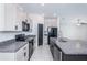 Modern kitchen with black appliances and granite countertops at 14906 Imperial Purple Ln, Wimauma, FL 33598